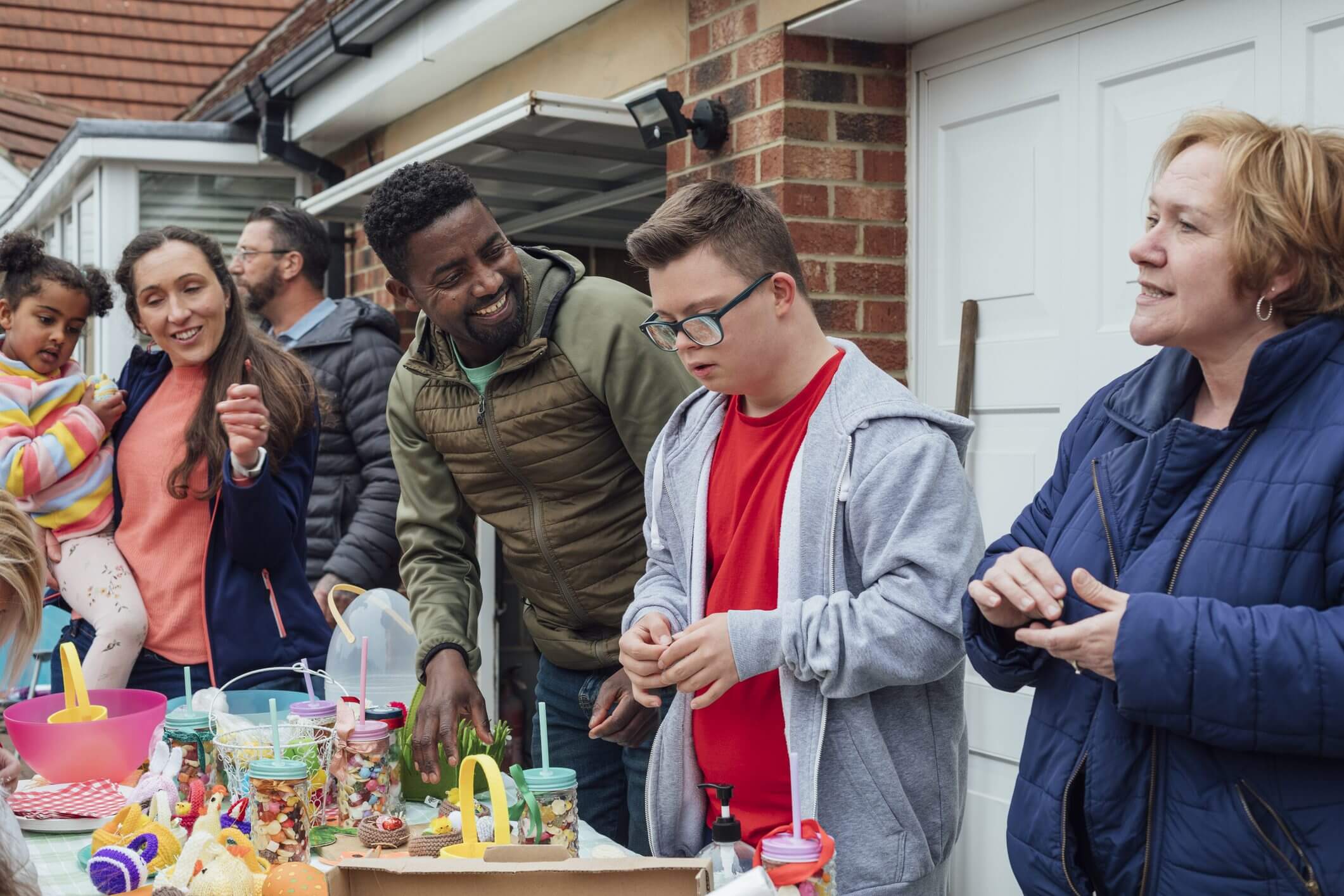 A group of friends engaged in a creative building activity outdoors.